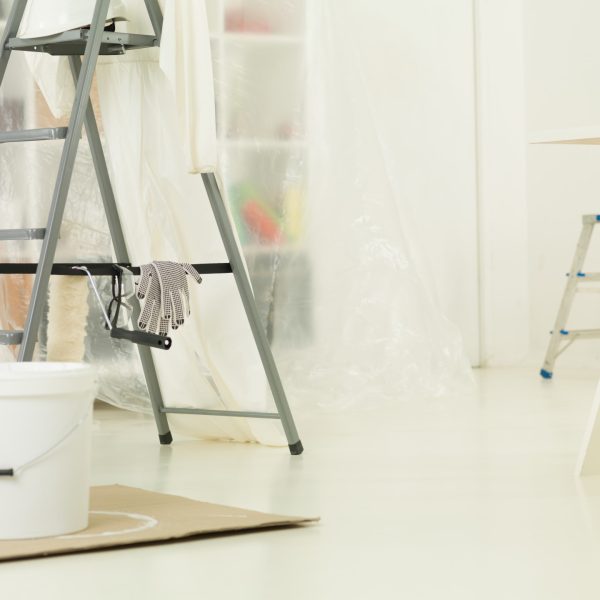 Construction brush, roller, aluminium ladder. The renovation of the house. home repairs. construction tools, products. Bright white apartment renovation.